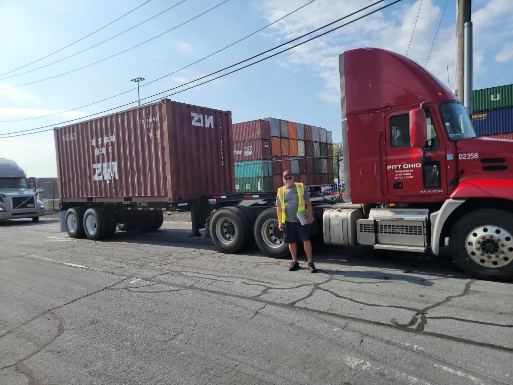 PITT OHIO Driver in front of container on chassis