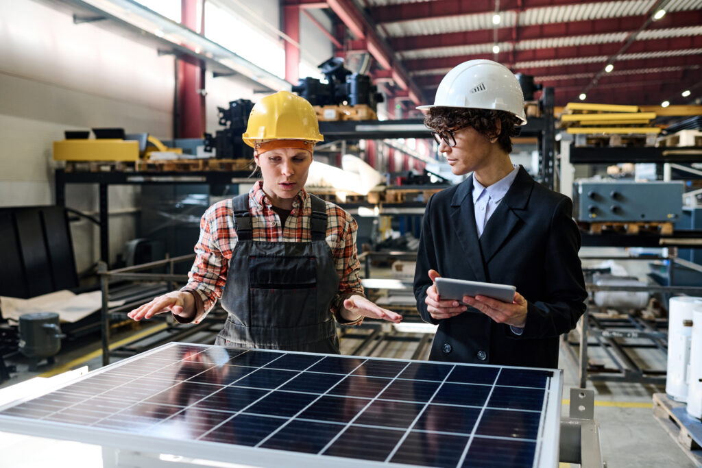 Warehouse workers review solar panel safety procedures